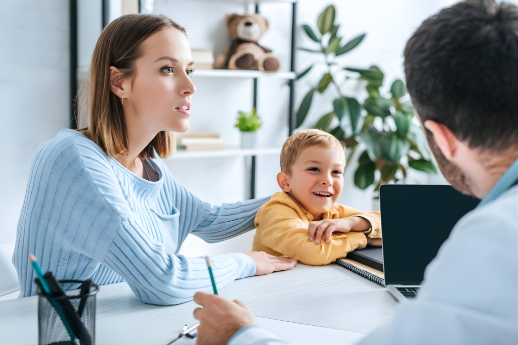 Parent consulting pediatrician about child health in general paediatrics clinic