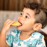 Child eating food during an oral food challenge