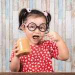 Child eating peanut butter as part of peanut oral immunotherapy