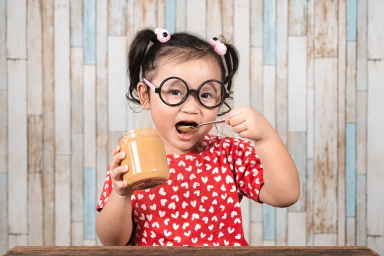 Child eating peanut butter as part of peanut oral immunotherapy
