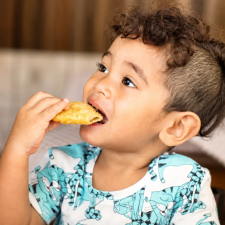 Child eating food during an oral food challenge