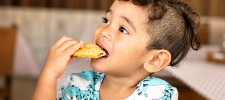 Child eating food during an oral food challenge