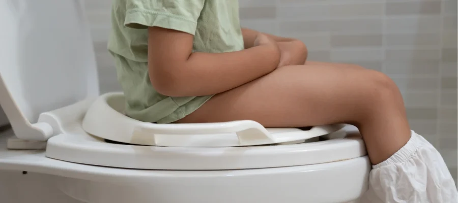 Child experiencing chronic diarrhea, a possible symptom of food allergy or gastrointestinal intolerance.